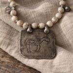 Cuentas claras con placa de plata con toro · en su ambiente